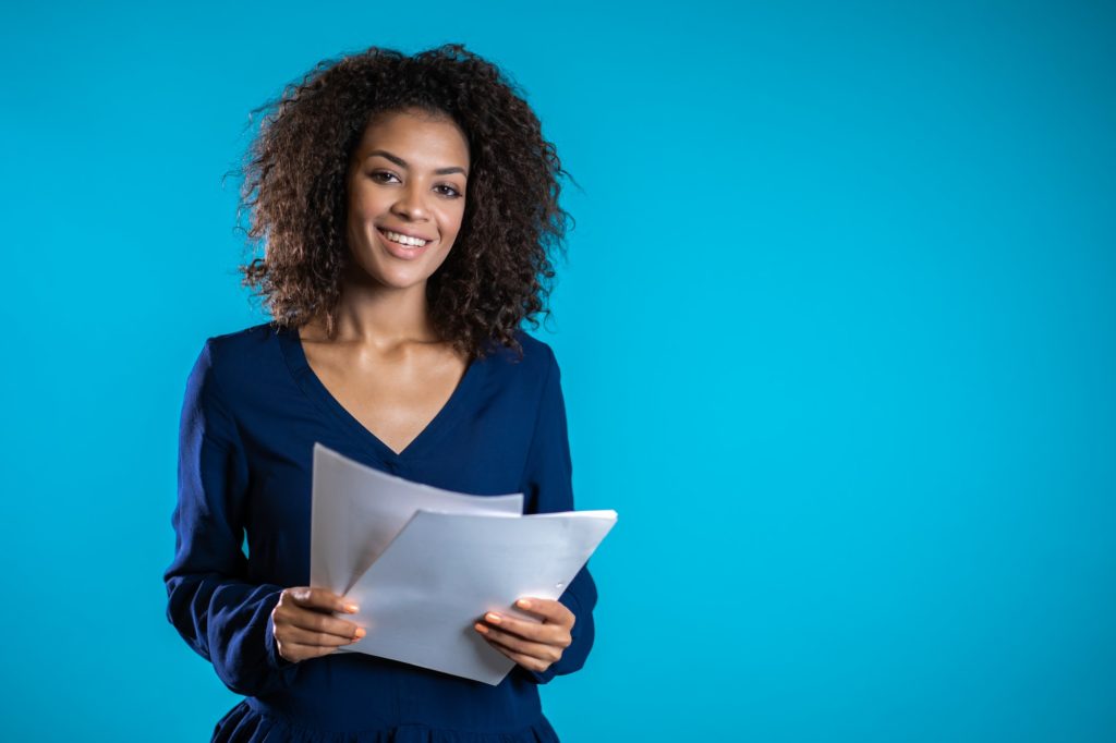 Pretty african american female boss checks documents, utility bills